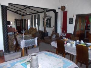 a living room with two tables and a couch at Villa Ocean Crest B&B in Gansbaai
