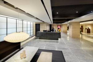 a lobby of a building with a table and a counter at Hotel PJ Myeongdong in Seoul