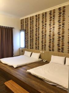 Postel nebo postele na pokoji v ubytování Taroko Inn