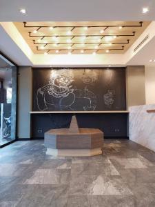 a lobby with a large wall with graffiti on it at YAKTHAI POSHTEL in Bangkok