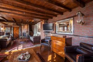 a living room with a brick wall at Villa Palaios Agios Athanasios in Palaios Agios Athanasios