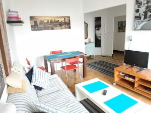 a living room with a couch and a table at Alojamiento Rúa Pino 110 in Vigo
