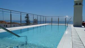 a swimming pool with a view of the ocean at Mena Plaza in Nerja