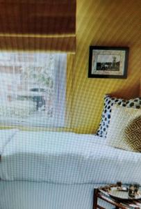 a bedroom with a white bed and a window at angolo23 in San Benedetto del Tronto