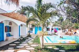 a pool at a house with two people swimming at The Koho Air Hotel in Gili Islands