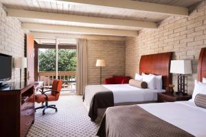 a hotel room with two beds and a desk and a television at Kayenta Monument Valley Inn in Kayenta +47 photos