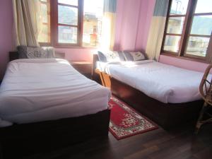 Letto o letti in una camera di STUPA VIEW INN