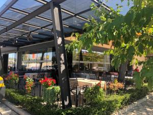 a patio with a table and chairs and flowers at Hotel Narenta in Metković
