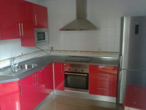 a kitchen with red cabinets and a stainless steel refrigerator at VFT LA PAZ in Baeza