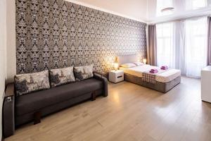 a bedroom with a bed and a couch in a room at Apartment with 2 bedroom near Opera House Gorodotska 27 str with parking in Lviv