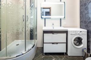 a bathroom with a washing machine and a sink at Apartment with 2 bedroom near Opera House Gorodotska 27 str with parking in Lviv +17 photos