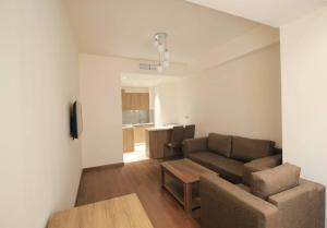 a living room with a couch and a table at Byuzand Yerevan Apartment in Yerevan