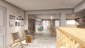 a hallway with chairs and a staircase with a table at Hotel Grand Nefeli in Vasiliki