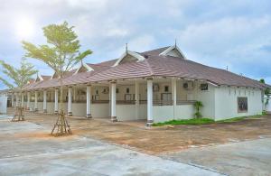 un gran edificio blanco con techo de metal en Sleep Hotel - SHA Certified en Surat Thani
