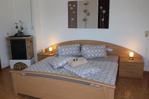 a bedroom with a bed with two lamps and two tables at Ferienhof Schaubmeier in Klaffer am Hochficht