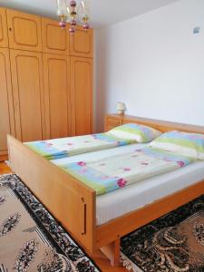 a bedroom with a bed with a wooden frame at Apartments Luce in Kornić