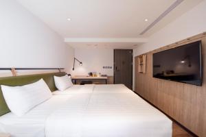 Ένα ή περισσότερα κρεβάτια σε δωμάτιο στο City Suites - Main Station