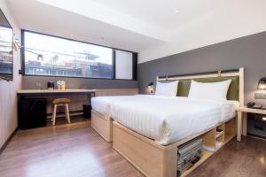 Ένα ή περισσότερα κρεβάτια σε δωμάτιο στο City Suites - Main Station