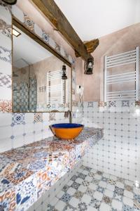 a bathroom with a bowl sink and a mirror at Old Side Boutique Hotel in Tbilisi City