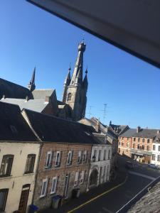 uma vista para um edifício com uma torre de relógio em Coeur de Solrézis em Solre-le-Château