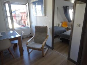 a room with a chair and a desk and a bed at Coeur de Solrézis in Solre-le-Château