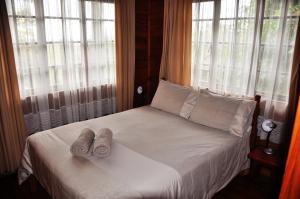 a bedroom with a bed with towels on it at Impala Niezel Lodge & Guest House in Hazyview