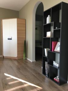a room with a book shelf and a white door at Three in Koblenz