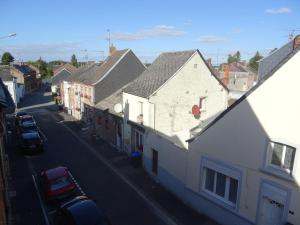 a view of a city street with buildings and cars at Coeur de Solrézis in Solre-le-Château