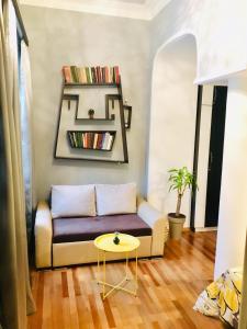 a living room with a couch and a table at Beauty in the Heart of the City in Tbilisi City