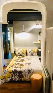 a bedroom with a bed with a flower pattern at Beauty in the Heart of the City in Tbilisi City