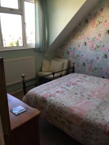 a bedroom with a bed, a desk, and a window at Weyside House in Weymouth