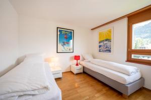 Postel nebo postele na pokoji v ubytování LAAX Homes - Casa Miro Nr 6