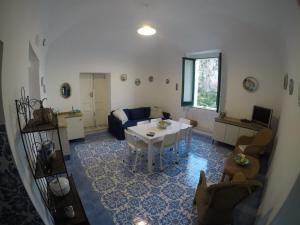 a living room with a white table and a couch at Villa La Mura in Atrani