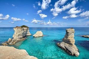 a view of the ocean with rocks in the water at Monolocale Cora in Corsano +12 photos
