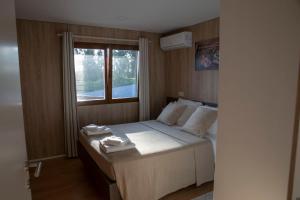 1 dormitorio con 1 cama con toallas en Quintinha do Periqueiro, en Castelo do Neiva