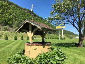 a statue of a house in the middle of a field at Scottish Inns Milford in Milford