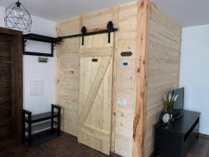 a wooden wall with a sliding barn door at Cozy seaside park apartment in Liepāja +15 photos