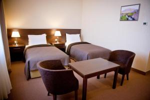 Postel nebo postele na pokoji v ubytování Kainar Hotel