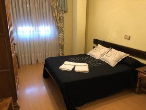Postel nebo postele na pokoji v ubytování HOSTAL EL ESCUDO