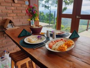 a wooden table with plates of food on it at The Cloud Resort in Kadugannawa +100 photos