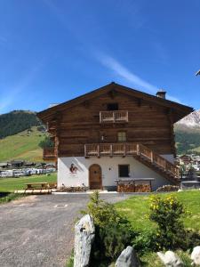 a large wooden building with a balcony at CHALET REMI-STELLA ALPINA in Livigno