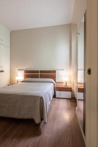 ein Schlafzimmer mit einem großen Bett und zwei Nachttischen in der Unterkunft Domus Seleqtia Plaza de Santiago in Cáceres