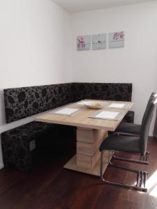 a wooden table and a chair in a room at Ferienwohnung Delphin in Schönwald