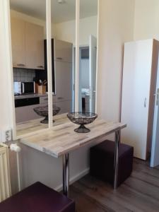 a dining table with a mirror in a kitchen at Ferienwohnung Delphin in Schönwald