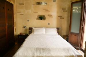 a bedroom with a bed with a white comforter at No 2 Spacious and Airy Apartment in Javea Medieval Village in Jávea