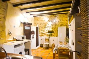 a kitchen with a sink and a table in a room at No 2 Spacious and Airy Apartment in Javea Medieval Village in Jávea
