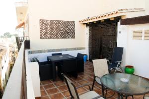 a patio with a table and chairs on a balcony at No 2 Spacious and Airy Apartment in Javea Medieval Village in Jávea +30 photos