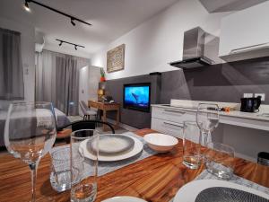 a kitchen with a table with wine glasses on it at Studio 307 - Ebene Square in Ebene