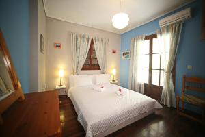 a bedroom with a bed with two stuffed animals on it at Villa Dimitra Nikiana in Nikiana