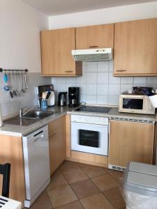 a kitchen with a sink and a stove top oven at Ferienwohnung im Haus Sommerwind in Schönberger Strand